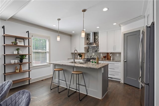 103 Willow Wood Cir SE, Atlanta, GA 30317 - kitchen featuring freestanding refrigerator, wall chimney exhaust hood, a sink, crown molding, and white cabinets