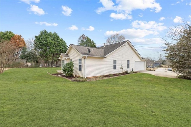 view of side of home featuring a garage and a yard