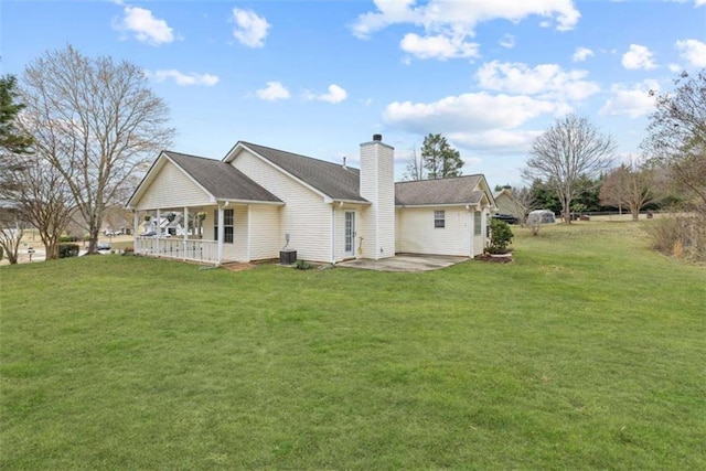 back of house with a yard, a patio area, central air condition unit, and covered porch