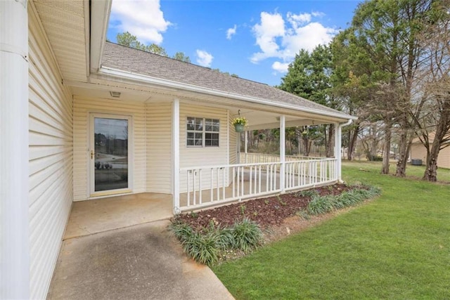 exterior space featuring a lawn and covered porch