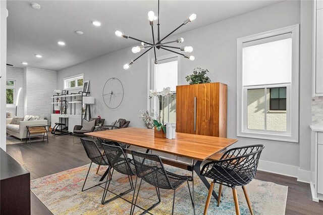 dining room with dark wood-style floors, a notable chandelier, recessed lighting, and baseboards