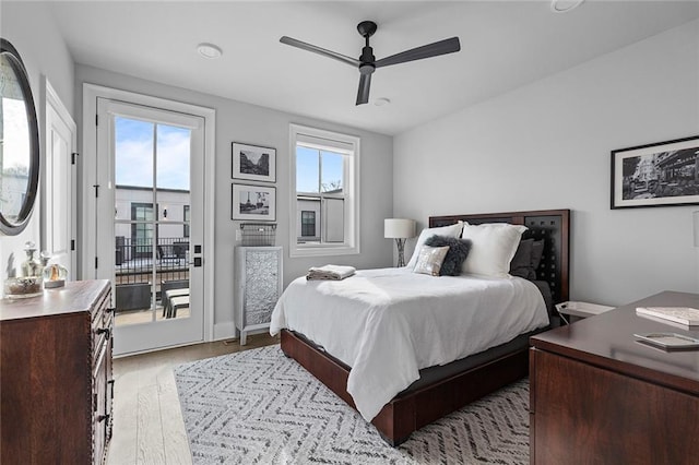 bedroom featuring ceiling fan, light wood-style floors, and access to exterior