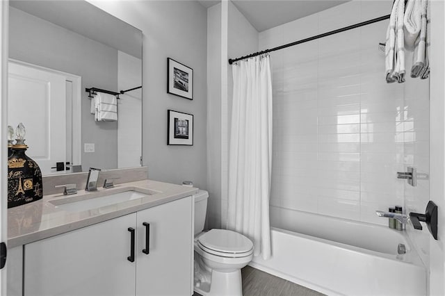 full bath featuring shower / bath combo with shower curtain, toilet, and vanity