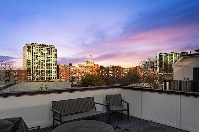 balcony at dusk with a view of city