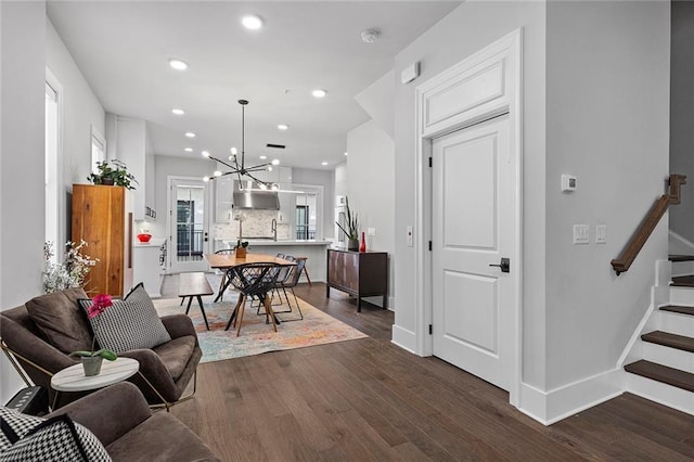 living room with recessed lighting, baseboards, dark wood-style floors, and stairs