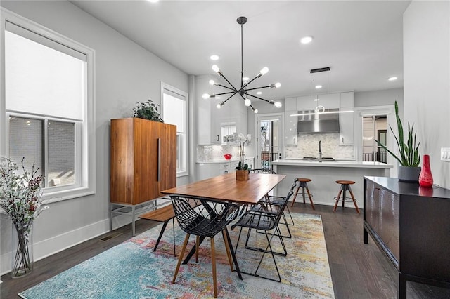 dining room featuring recessed lighting, dark wood-style floors, baseboards, and a chandelier