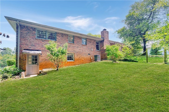 4581 Newcastle Cir, Lithonia, GA 30038 - rear view of property with a chimney, a lawn, and brick siding