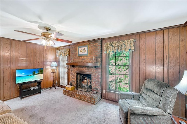 4581 Newcastle Cir, Lithonia, GA 30038 - living room with light colored carpet, wooden walls, a fireplace, and a ceiling fan