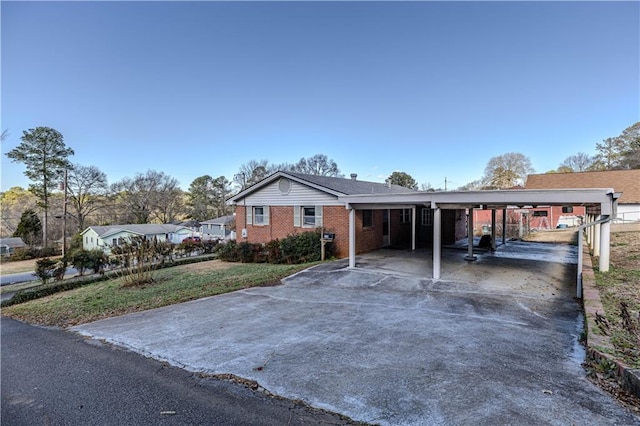 ranch-style house with a carport and a front lawn