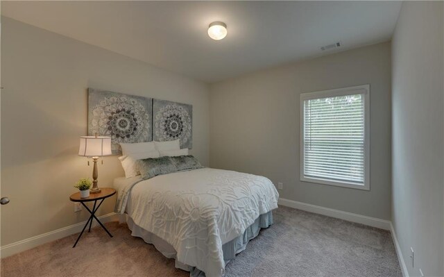 bedroom featuring light colored carpet