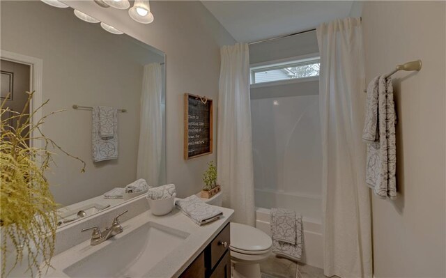 full bathroom with toilet, vanity, and shower / tub combo with curtain