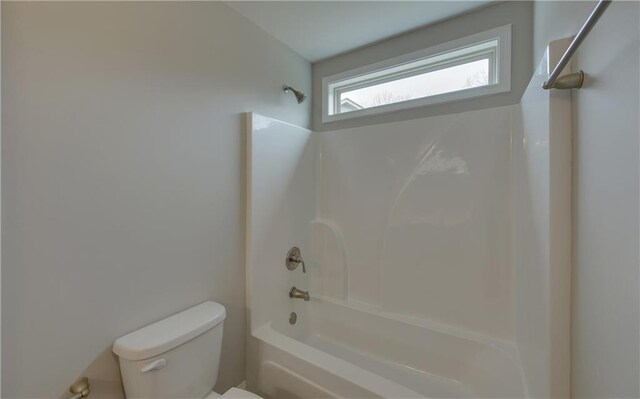 bathroom with tub / shower combination and toilet