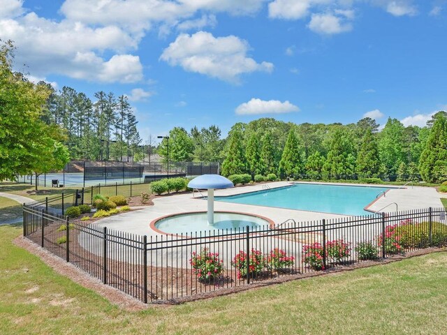 view of swimming pool with a patio area and tennis court