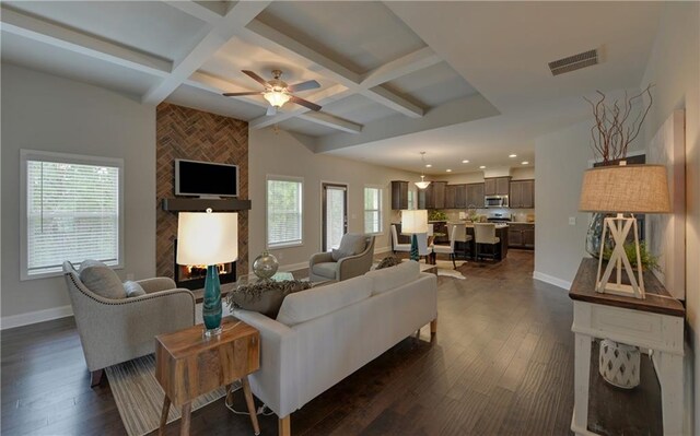 living room featuring ceiling fan, beam ceiling, dark hardwood / wood-style flooring, and coffered ceiling