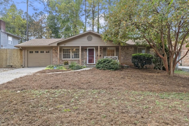 single story home featuring covered porch and a garage