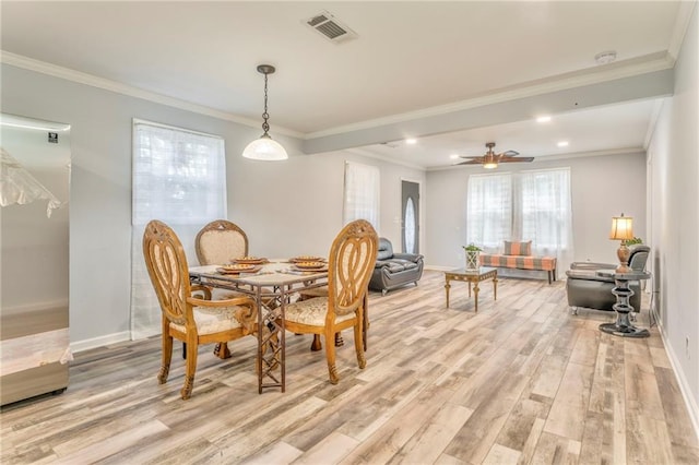 dining room featuring ornamental molding, ceiling fan, and light wood-type flooring