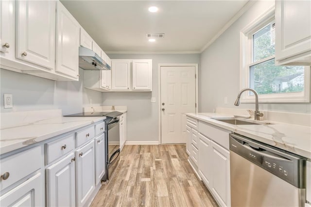 kitchen with white cabinetry, appliances with stainless steel finishes, sink, and light stone counters