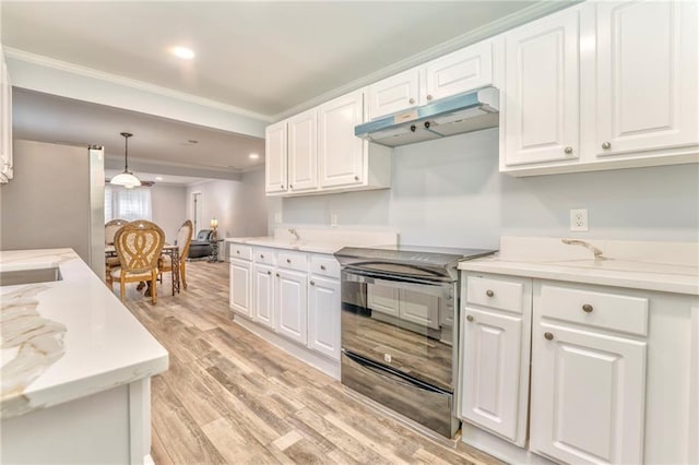 kitchen with electric stove, stainless steel fridge, hanging light fixtures, and white cabinets