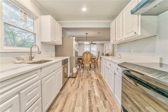 kitchen featuring stainless steel dishwasher, range, sink, and white cabinets