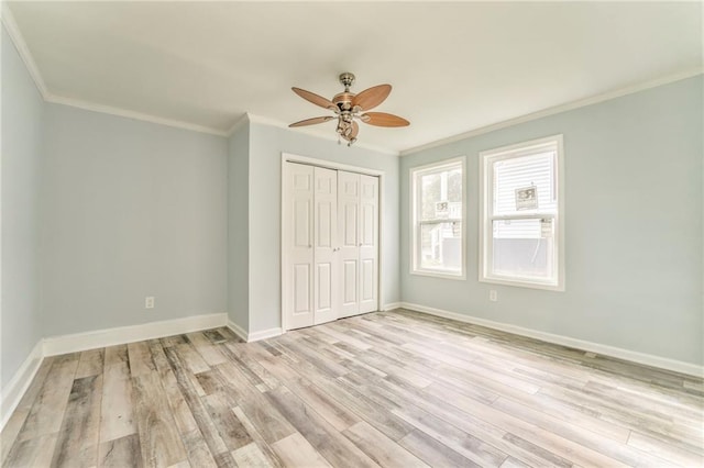 unfurnished bedroom with ornamental molding, light hardwood / wood-style floors, and a closet