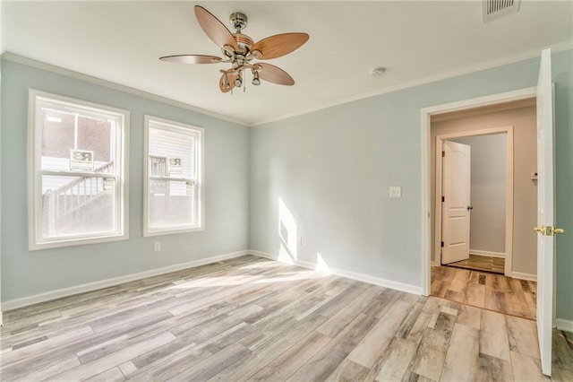 spare room featuring ornamental molding, ceiling fan, and light hardwood / wood-style floors