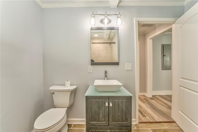 bathroom featuring ornamental molding, vanity, electric panel, and toilet