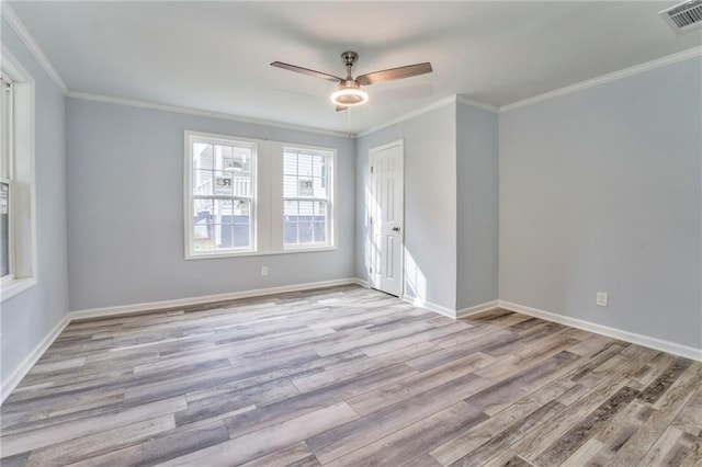 spare room featuring crown molding, ceiling fan, and light wood-type flooring