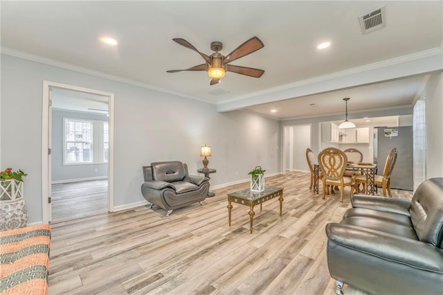 living room with ornamental molding, ceiling fan, and light hardwood / wood-style floors