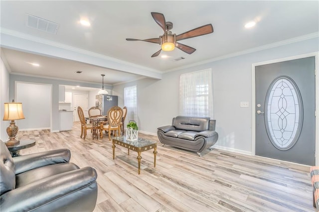 living room featuring ornamental molding, ceiling fan, and light wood-type flooring