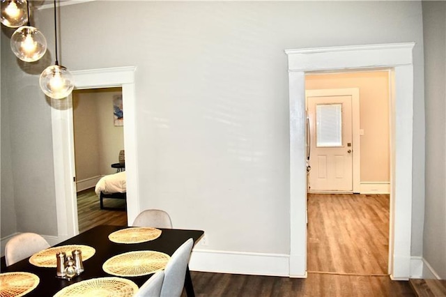 dining space with hardwood / wood-style flooring