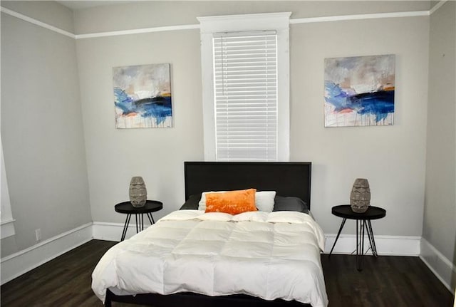 bedroom with dark hardwood / wood-style flooring