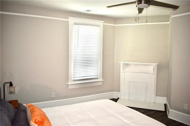 bedroom with ceiling fan and dark hardwood / wood-style floors