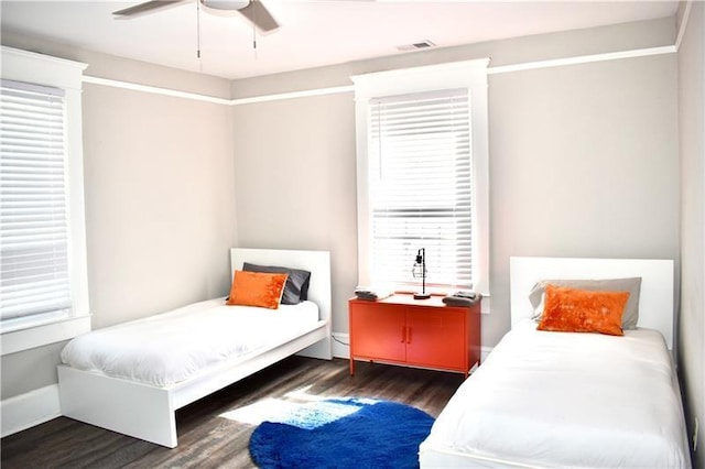 bedroom featuring ceiling fan and dark wood-type flooring