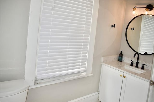 bathroom with toilet and vanity