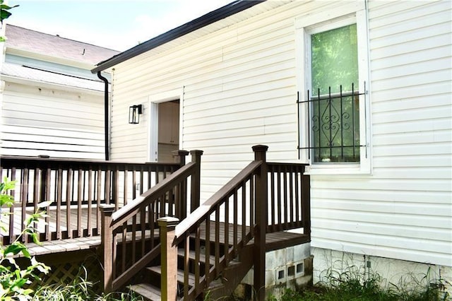 view of exterior entry featuring a wooden deck