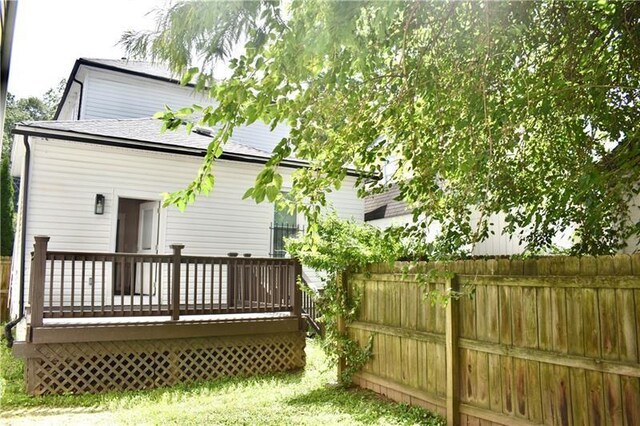 back of house with a wooden deck