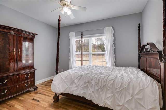 bedroom featuring ceiling fan, light wood-style flooring, and baseboards