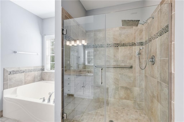 bathroom with a garden tub, vanity, and a stall shower