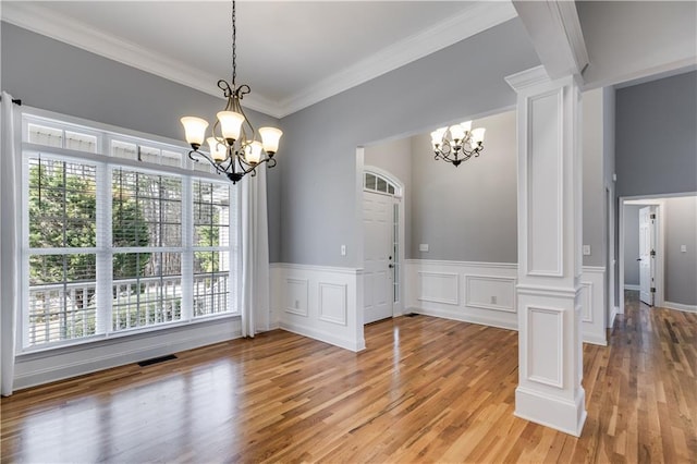 unfurnished dining area with a healthy amount of sunlight, visible vents, and a notable chandelier