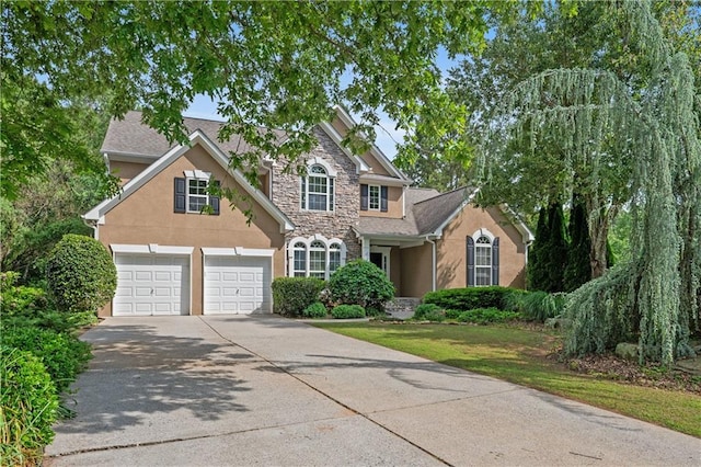 2595 Glaramara Ter, Cumming, GA 30041 - traditional home with stone siding, stucco siding, driveway, and an attached garage