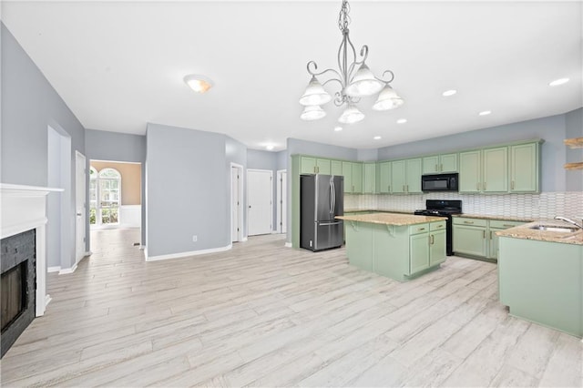 2595 Glaramara Ter, Cumming, GA 30041 - kitchen featuring freestanding refrigerator, black microwave, green cabinetry, stove, and backsplash