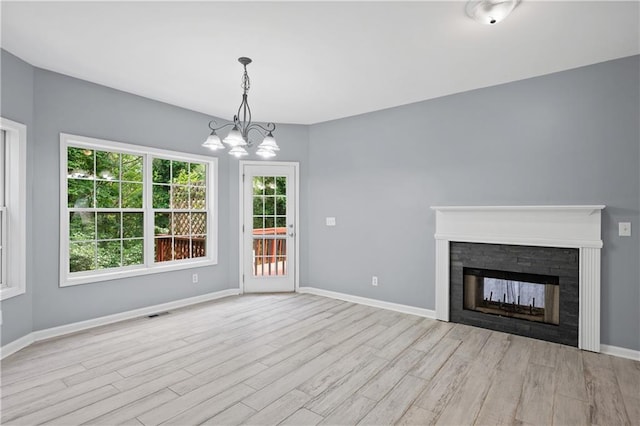 2595 Glaramara Ter, Cumming, GA 30041 - unfurnished living room with wood finished floors, a chandelier, and baseboards
