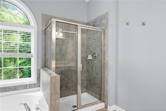 2595 Glaramara Ter, Cumming, GA 30041 - bathroom with a stall shower, a garden tub, and baseboards