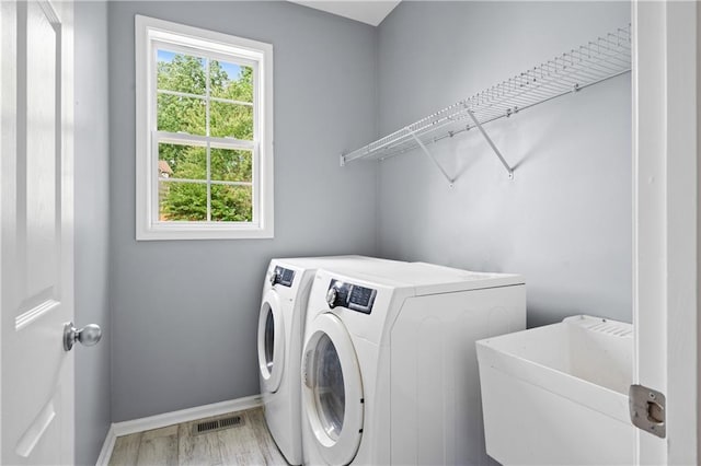 2595 Glaramara Ter, Cumming, GA 30041 - laundry area featuring separate washer and dryer, plenty of natural light, and baseboards