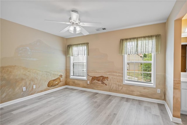 2595 Glaramara Ter, Cumming, GA 30041 - empty room with wood finished floors, ceiling fan, healthy amount of natural light, and baseboards