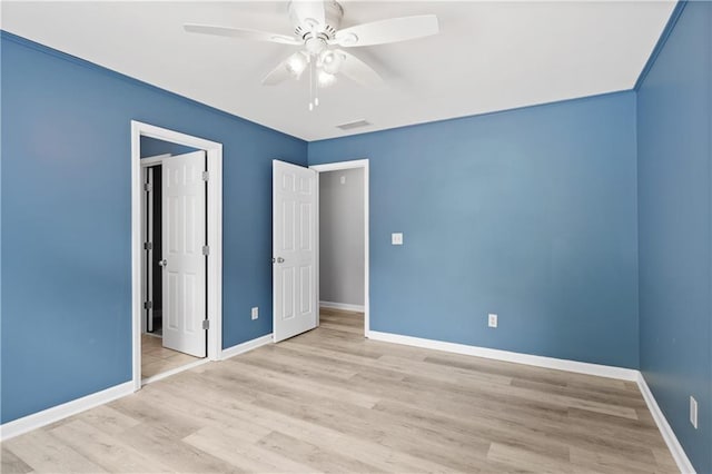 2595 Glaramara Ter, Cumming, GA 30041 - unfurnished bedroom featuring baseboards, wood finished floors, and ceiling fan