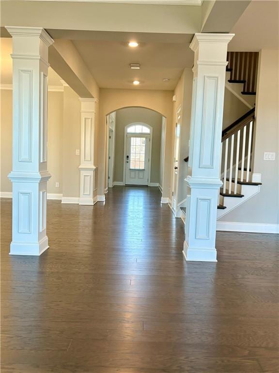 foyer with dark hardwood / wood-style flooring and decorative columns