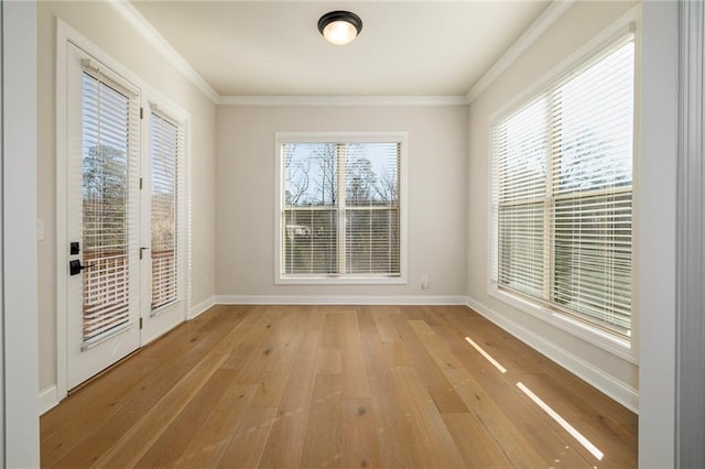 unfurnished room with crown molding and light wood-type flooring