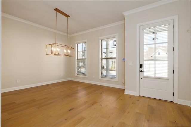 interior space featuring ornamental molding, a healthy amount of sunlight, and light hardwood / wood-style floors