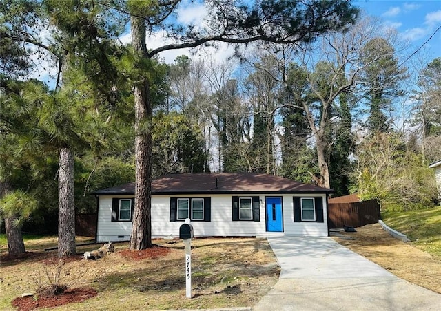 ranch-style house with driveway, crawl space, and fence